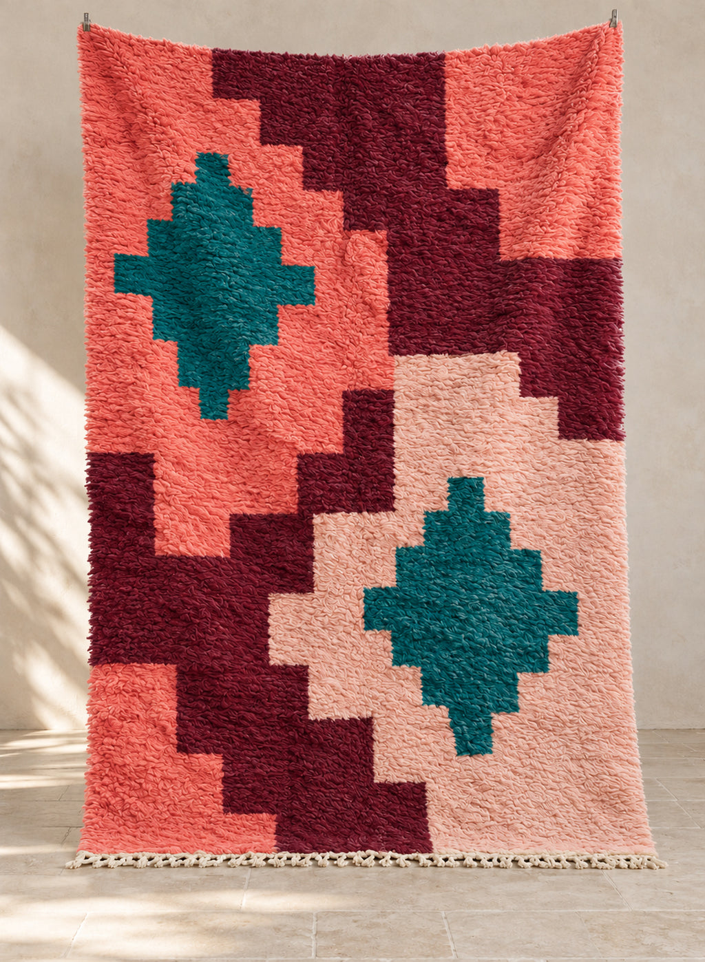 Coral Boujaad rug with stepped blocks and teal diamonds, hanging full view
