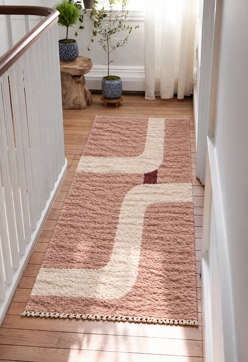 Blush Beni Ourain rug with an ivory curved path in a styled interior
