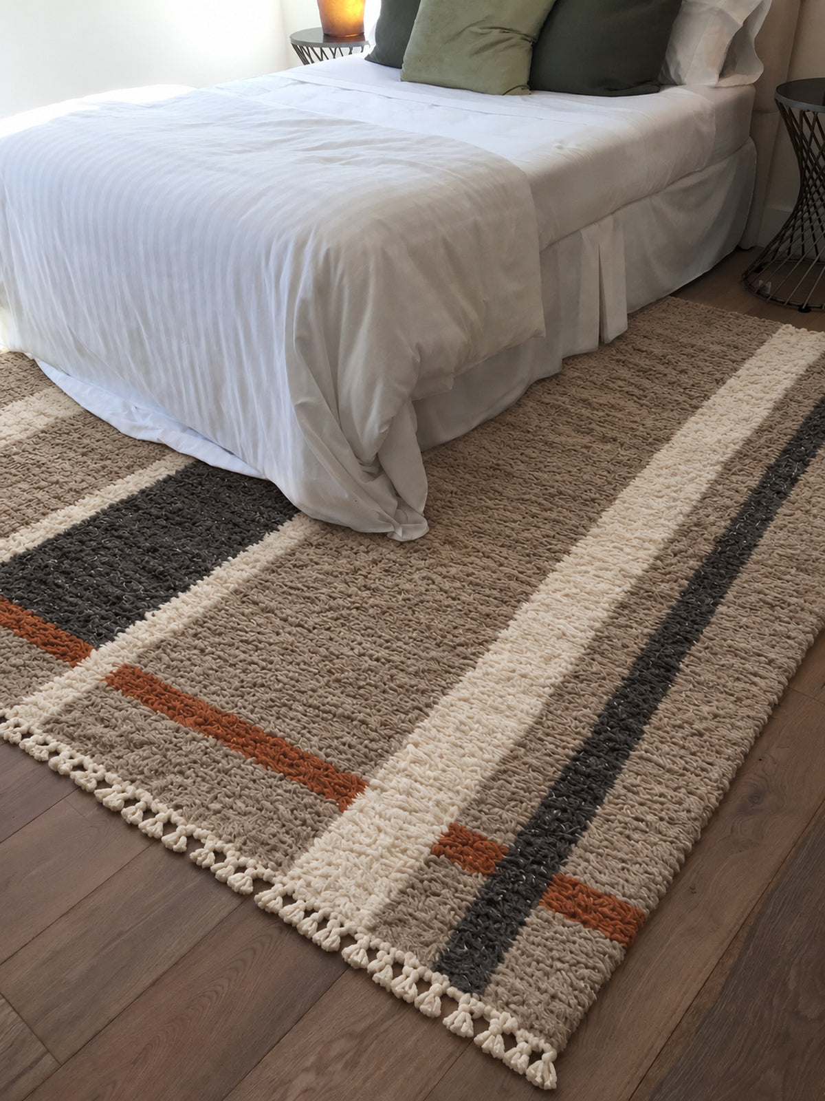 Taupe Beni Ourain rug with vertical charcoal and ivory bands in a styled interior