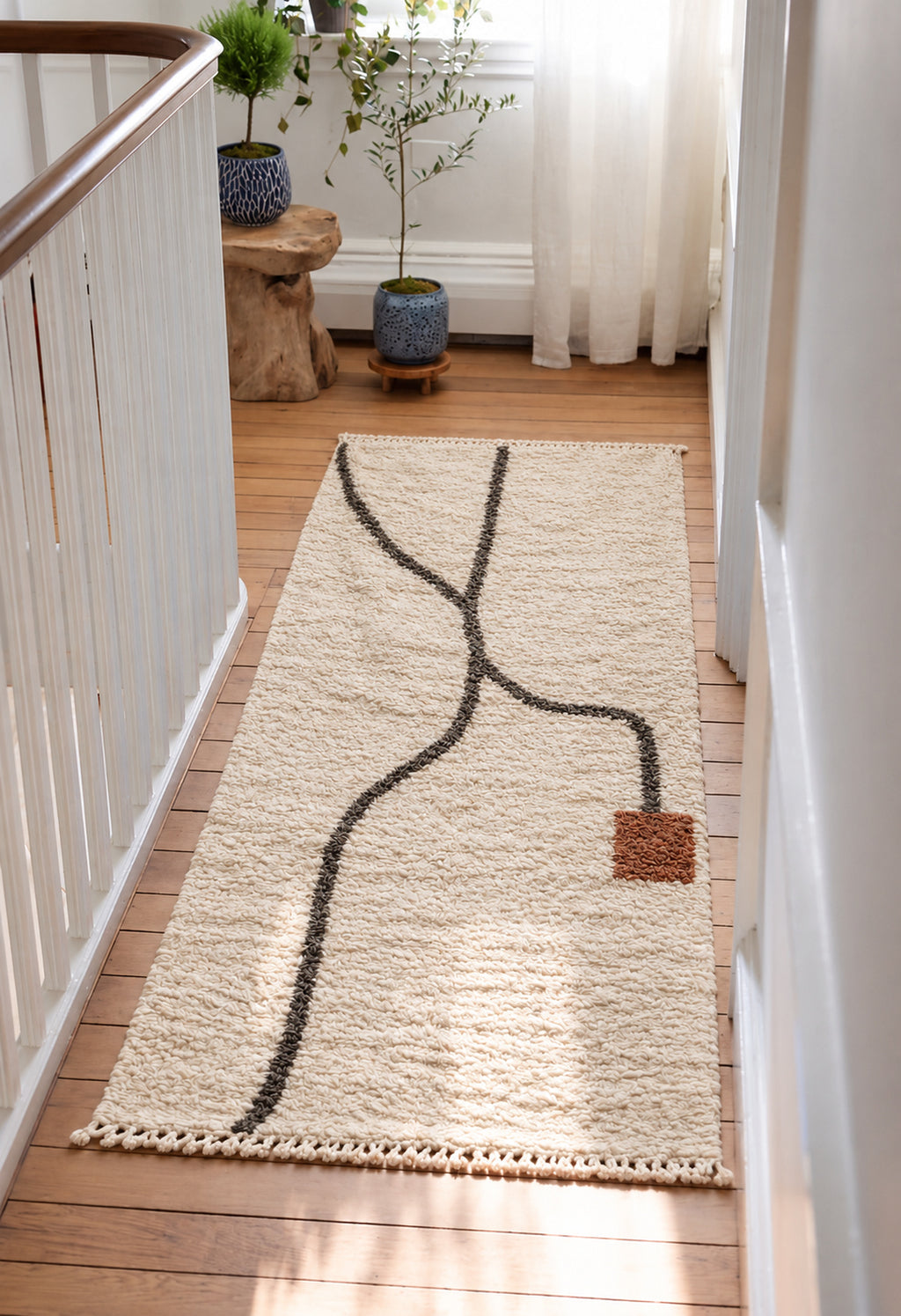 Ivory Beni Ourain rug with a charcoal river line in a styled interior