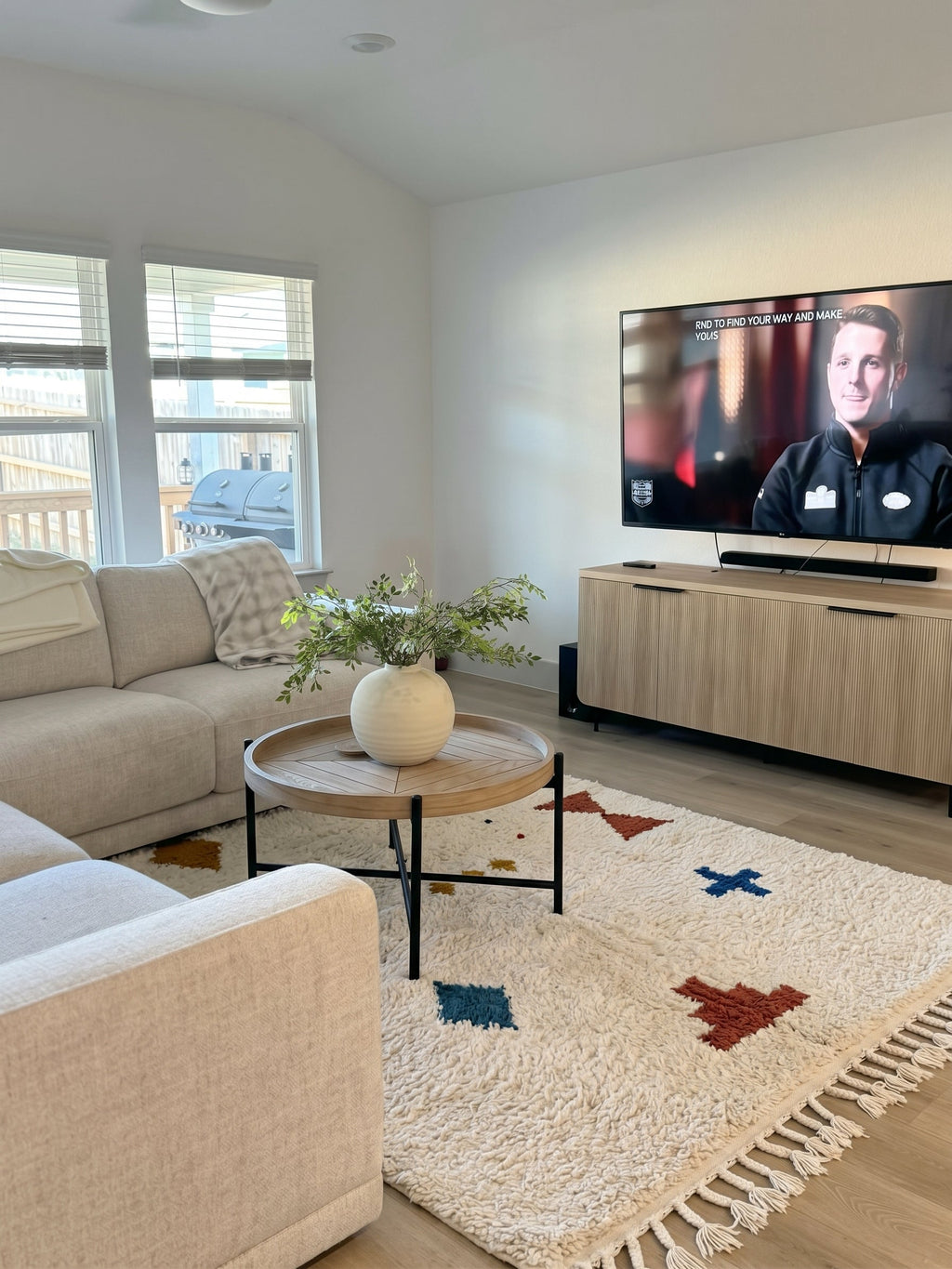 Ivory Azilal rug with scattered colorful symbols in a living room