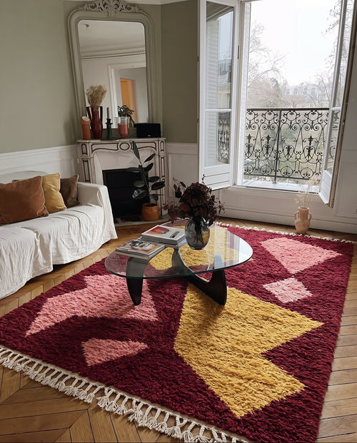 Burgundy Tazart Boujaad rug with mustard shards in a living room