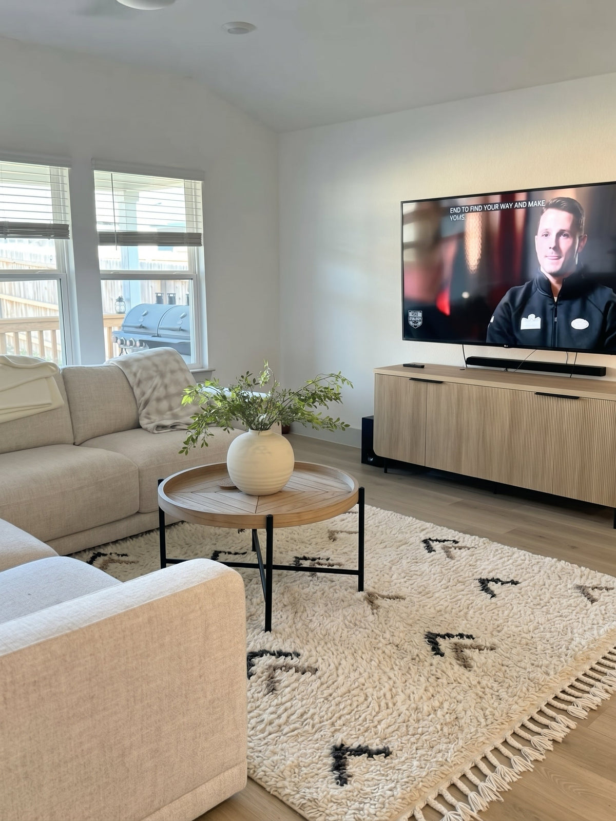 Ivory Beni Ourain rug with scattered arrows in a living room