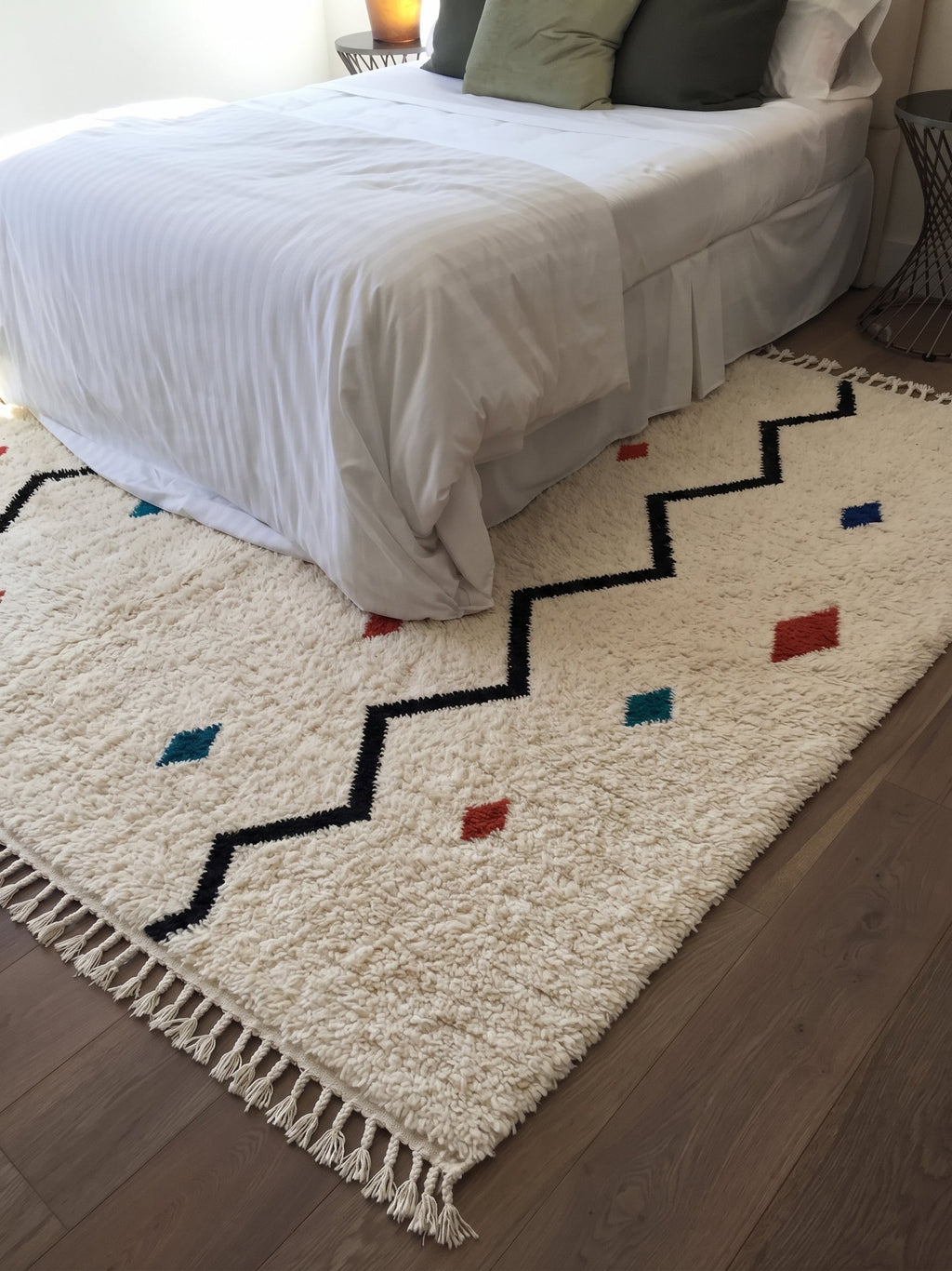 Ivory Azilal rug with a black zigzag and colorful accents in a bedroom