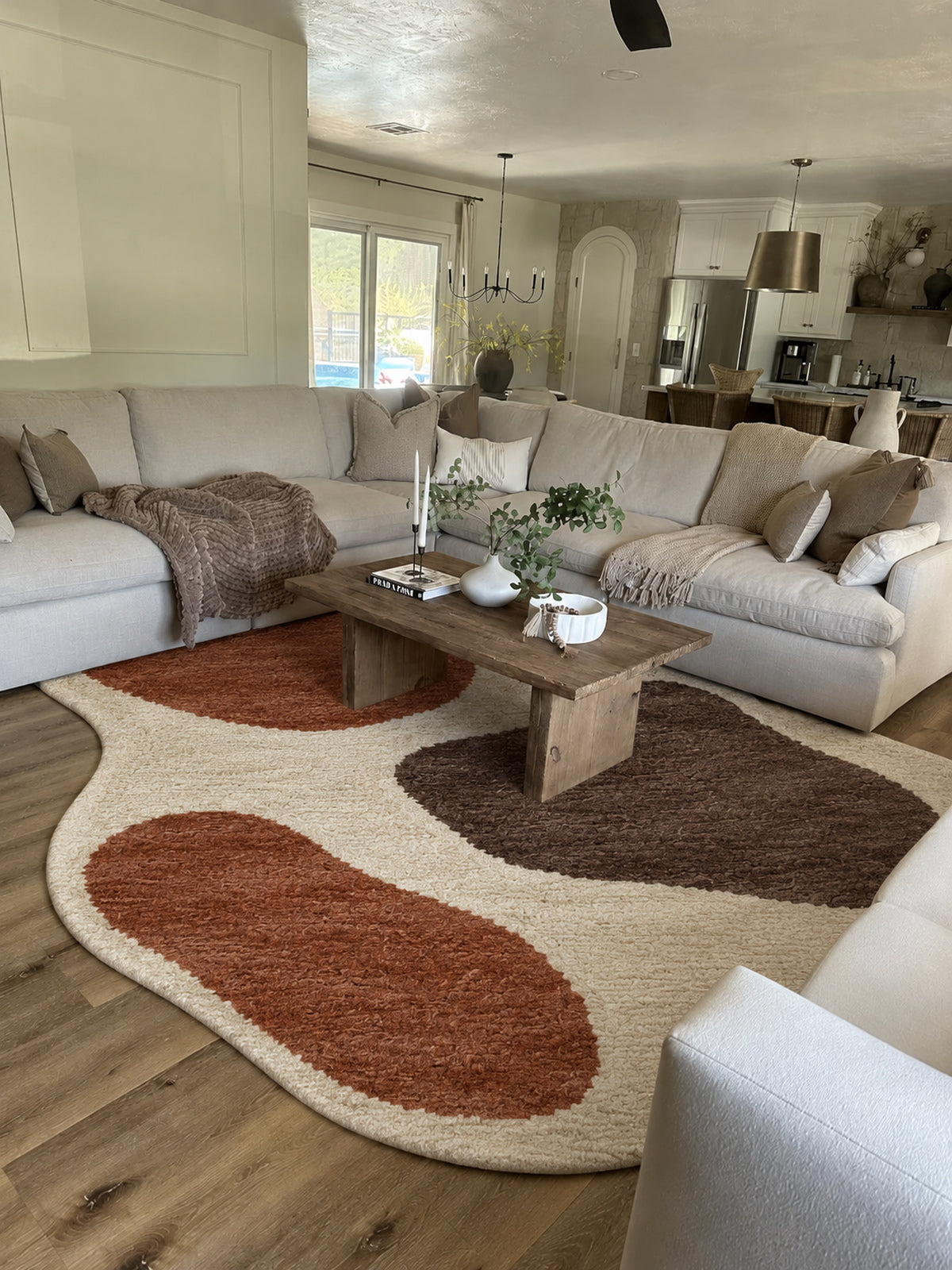 Ivory Beni Ourain shaped rug with rust and brown organic shapes in a styled interior